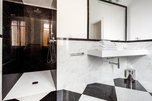 a bathroom with a sink and a mirror at PLEY Cagliari Boutique Suites in Cagliari