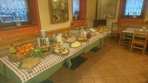 a table with food on it in a room at Casa Vacanze Ca' De Val in Campodolcino