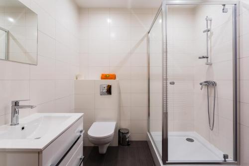 a bathroom with a shower and a toilet and a sink at Tenis Park Advantage in Bielsko-Biala