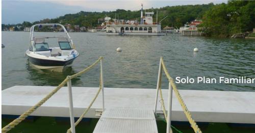 a boat is docked at a dock in the water at Residencial Club Nautico Teques in Tequesquitengo