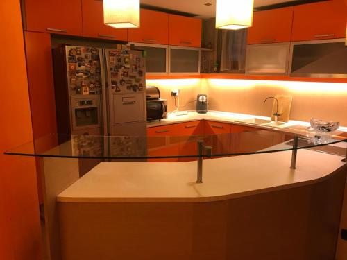 a kitchen with a glass counter with a refrigerator at Fantastic 3 bedroom Apartment in Sofia