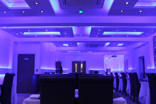 a conference room with chairs and purple lights at The Charles Hotel in Chatham