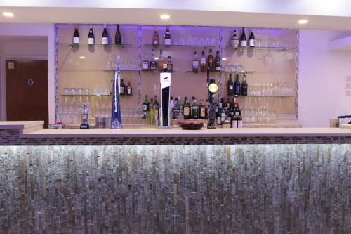 a bar with a bunch of bottles of wine at The Charles Hotel in Chatham