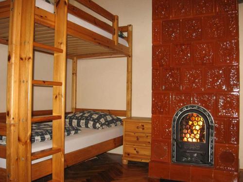 a bedroom with two bunk beds and a fireplace at Faragó Apartman in Nyíregyháza