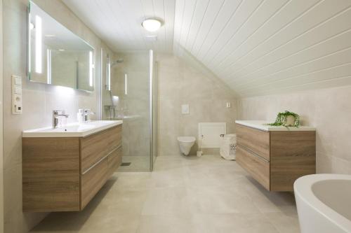 a bathroom with a sink and a shower and a toilet at Rasmusgarden in Stranda