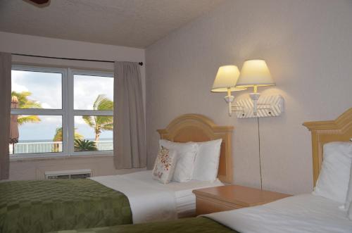 a hotel room with two beds and a window at La Terrace Oceanfront in Hollywood