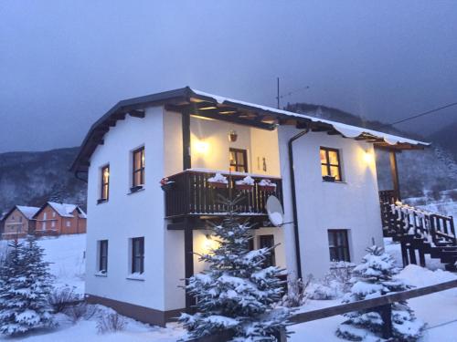 a large building with a balcony in the snow at Chalet Ivana in Kupres