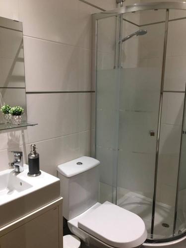 a bathroom with a shower and a toilet and a sink at NEW APT center 1 min walk beach/river/casino!!! in Figueira da Foz