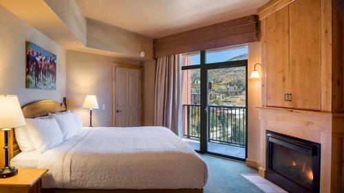 a bedroom with a bed and a fireplace at The Steamboat Grand in Steamboat Springs