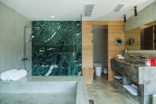 a bathroom with a large shower and a sink at Anadu Private House in Huzhou