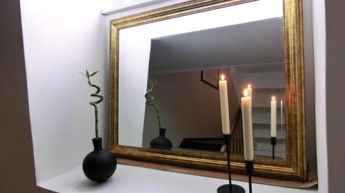 two vases sitting on a table in front of a mirror at Apartment KiezFlair in Potsdam