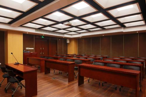 a conference room with desks and chairs and lights at Mason Hotel in Shanghai