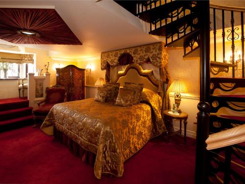 a bedroom with a large bed in a room at Coombe Abbey Hotel in Coventry