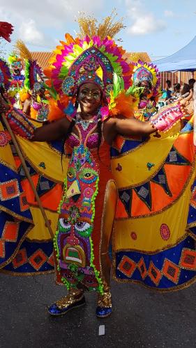 a woman in a colorful outfit with a float at Bon Bini Lagun Curacao in Lagun