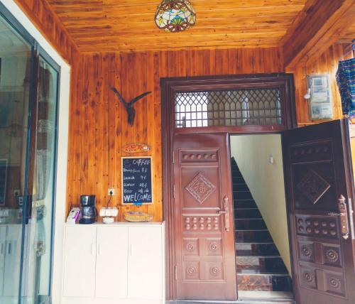 an entrance to a building with a staircase and a door at Zhangjiajie one step to heaven inn (Yangjiajie ticket office) in Zhangjiajie