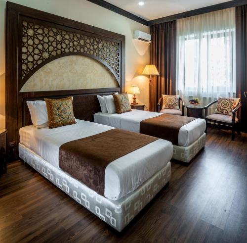 Un ou plusieurs lits dans un hébergement de l'établissement Orient Star Hotel