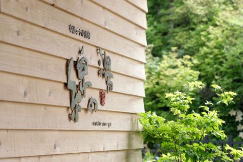 a wall with clocks on the side of a building at Kusatsu Hotel Bekkan Wata no Yu (Adult Only) in Kusatsu