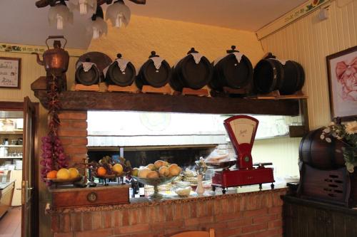 a kitchen with a fireplace with chickens on a shelf at Locanda Zita in Sestola