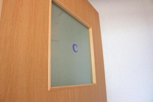 a window with a blue c sticker on it at Ikkyu For Backpackers 19 in Hitoyoshi