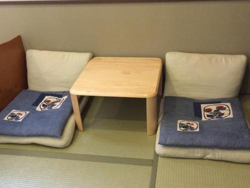 a table and two chairs with pictures on them at Shikino Yado Subaru in Chino