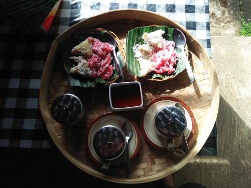 a plate of food on top of a table at ESA di Kubu Homestay in Singaraja