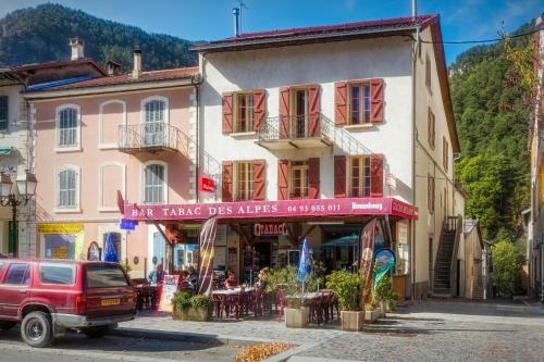 a red truck parked in front of a building at Relais Des Alpes in Guillaumes