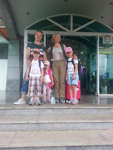a group of people standing in front of a building at Jeju Feel House in Jeju