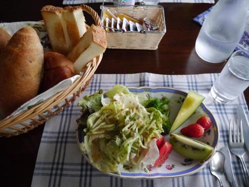 a plate of salad and bread and a basket of bread at Shikino Yado Subaru in Chino