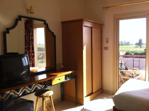Postel nebo postele na pokoji v ubytování New Memnon Hotel