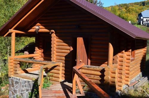a log cabin with a door on the side of it at Villa U Tsymbora in Sinyak