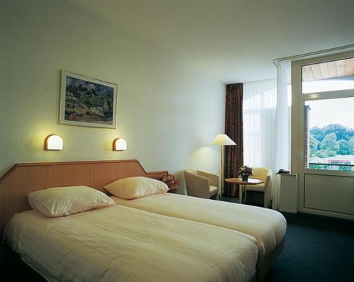 Postel nebo postele na pokoji v ubytování Hotel Dekkers