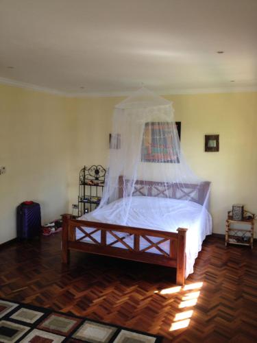 a bedroom with a bed with a canopy at Villa Delice, entiere, exquisite avec piscine privée in Rivière Noire