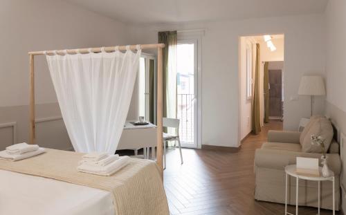 a hotel room with a bed and a living room at BED IN BO Porta San Mamolo in Bologna
