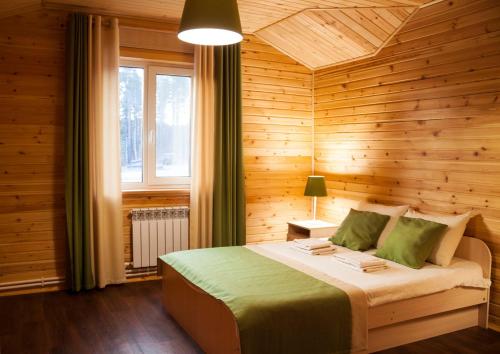 a bedroom with a bed, a lamp, and a window at Ladoga Fjord in Koirinoya