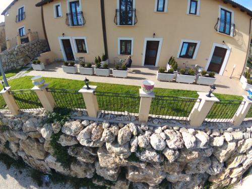 a stone retaining wall in front of a house at Borgo Donna Teresa in Castel San Vincenzo
