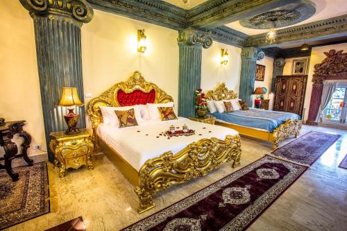 a bedroom with a large gold bed in a room at Pingdoi Hualin Boutique Hotel in Chiang Mai