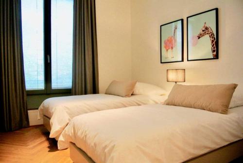 a bedroom with two beds and a giraffe on the wall at BonusFeature Apartments in Berlin