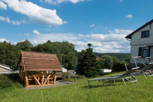 a gazebo in the yard of a house at Ferienwohnung Rennsteigblick in Tambach-Dietharz
