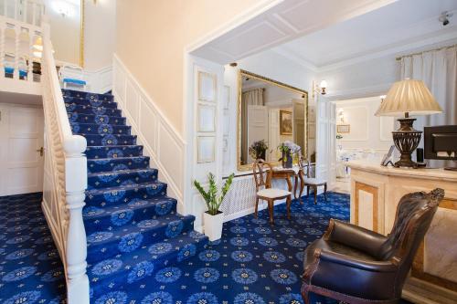 a staircase in a home with blue carpet at Dwór Hetman in Jarosław