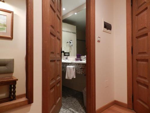 
a bathroom with a sink and a mirror at Parador de Vilalba in Villalba
