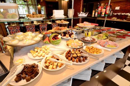 a buffet with many different types of food on a table at Greenhotels Roissy Parc des Expositions in Tremblay En France