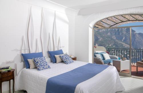 En eller flere senge i et værelse på Hotel Le Agavi