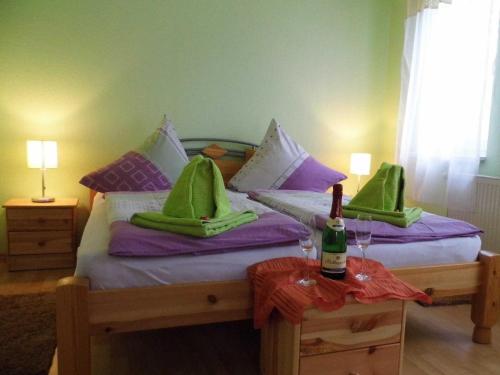 NepperminにあるFerienhaus am Nepperminer Seeのベッドルーム1室(緑と紫の枕が備わるベッド1台付)