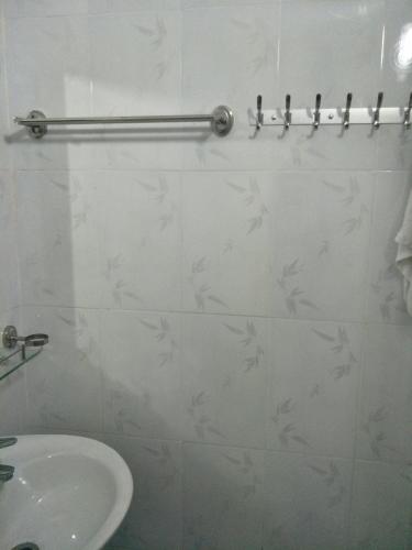 a white bathroom with a sink and a toilet at Ngan Ha Homestay in Ha Giang
