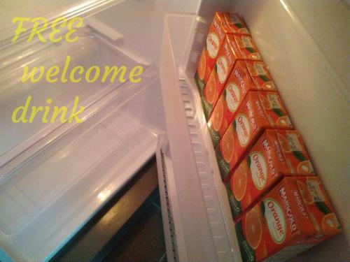 an open refrigerator with a bunch of coke drinks at D'Ashikin Village Stay in Seremban