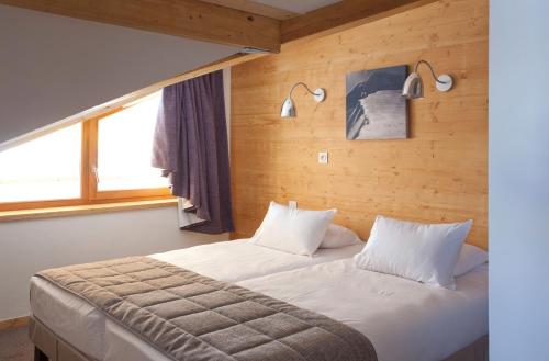 Кровать или кровати в номере Lagrange Vacances l'Alpenrose
