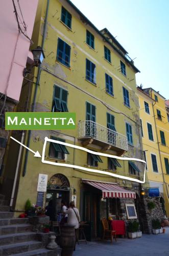 a yellow building with a sign that reads marina at Mainetta Sea View Apartment with AC in Vernazza