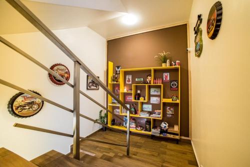 a hallway with a staircase with a book shelf at Fox Rooms Aparthotel in Stara Zagora