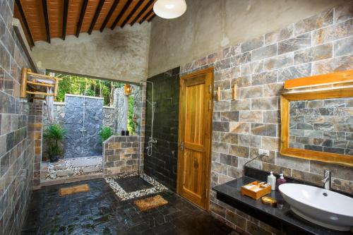 a bathroom with a sink and a mirror at Valley Village Resort Phu Quoc in Phú Quốc