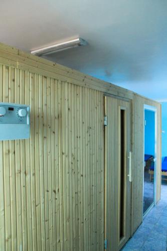 a room with a wooden wall with a door at Ambassador Hotel in Addis Ababa